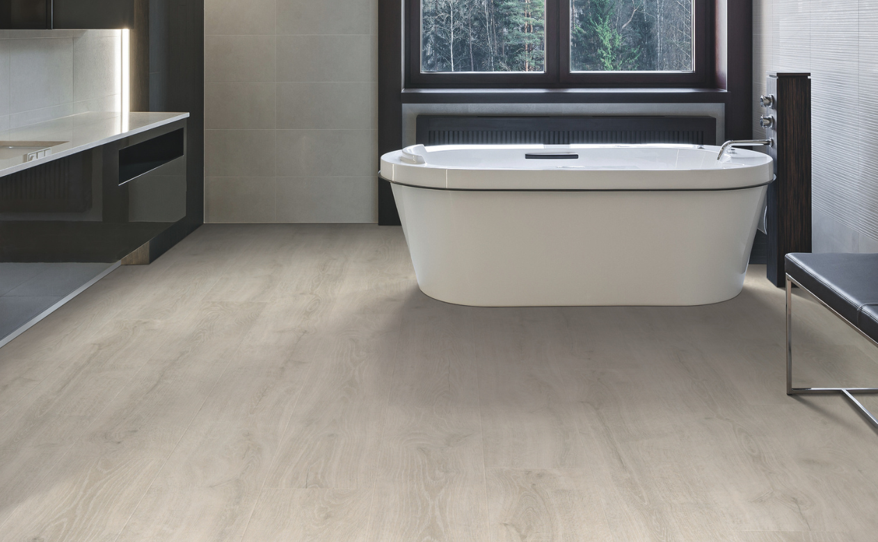 Bathroom with laminate flooring and a bathtub